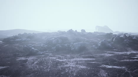 stones in snow on moutain in summer