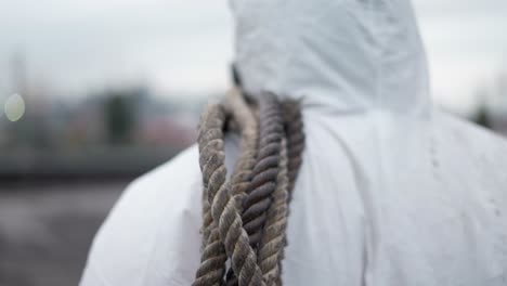 worker in protective walk outdoors with ropes by abandoned place