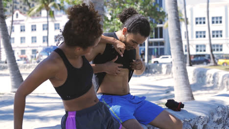 Woman-looking-at-muscles-of-boyfriend