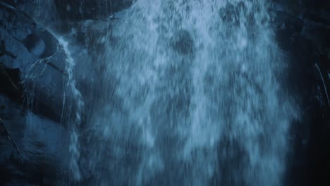 Tilt-down-close-up-of-a-majestic-waterfall-in-a-rainforest