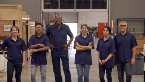 engineers and apprentices walk towards camera in factory