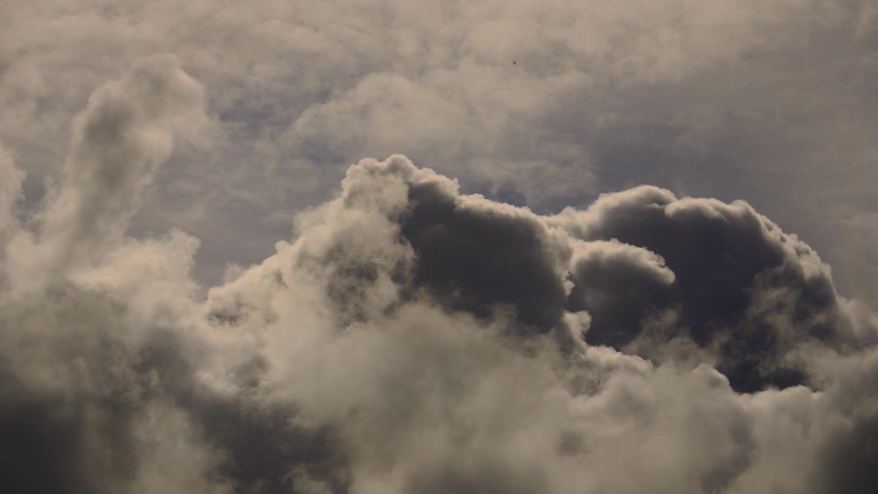 Dark Fast Rising Storm Clouds Pushing Upwards Across the Sky. Perfect for travel videos, commercial backgrounds, weather related presentations, cinematic compositing plates. 4K.
