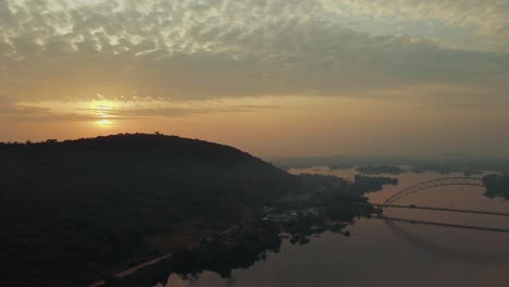 aerial shot panning to the right to have a clear view of adomi bridge and the volta river at akosombo atimpoku, eastern region