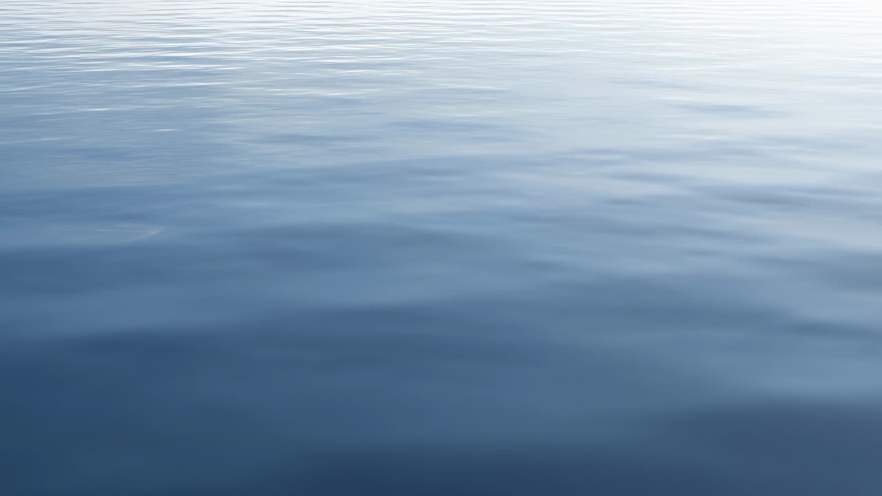 Gentle Ripples on a Calm Blue Water Surface