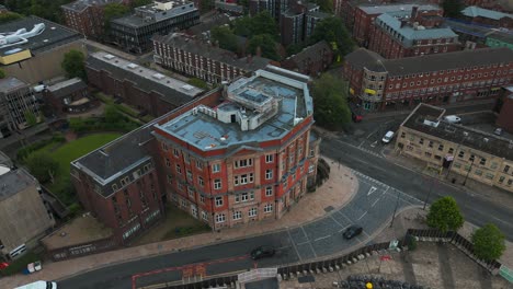 urban landscape of liverpool city center with rooftops, streets and some cars driving, seen from above