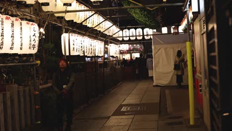 people walking in a traditional asian market at night