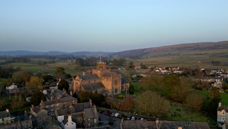 Aerial-footage-of-the-Medieval-village-of-Cartmel-in-the-English-Lake-District-it-has-a-rich-heritage,-and-varied-list-of-activities-for-visitors-and-tourists