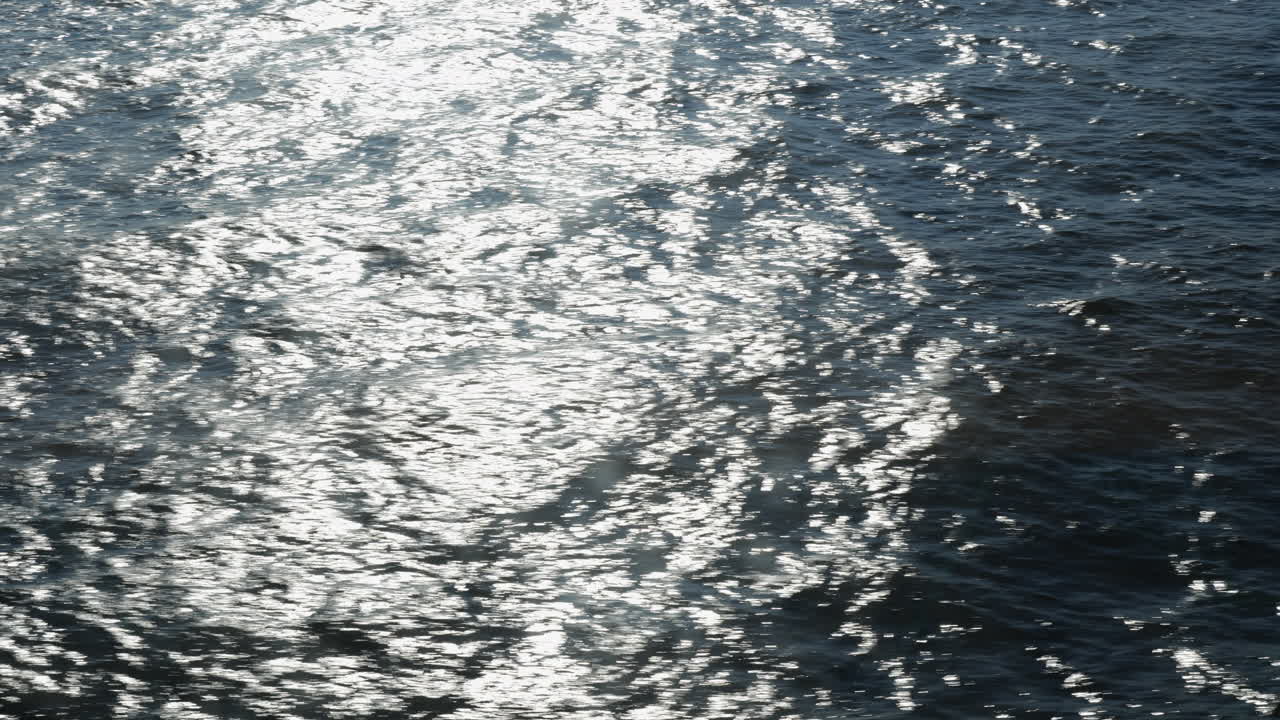 Sea surface shining abstract, bright sun reflections in water through a window of cruise ship