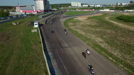 Motorcyclists-starting-on-racing-track.-Aerial-view-moto-racers-driving-on-race