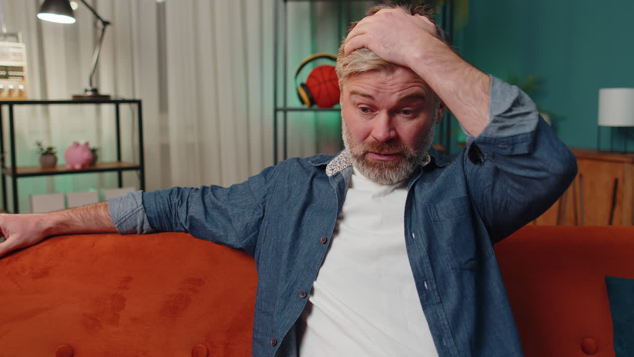 hombre maduro en casa sufre de una situación injusta problema, ruptura, depresión, sentirse mal, agotamiento