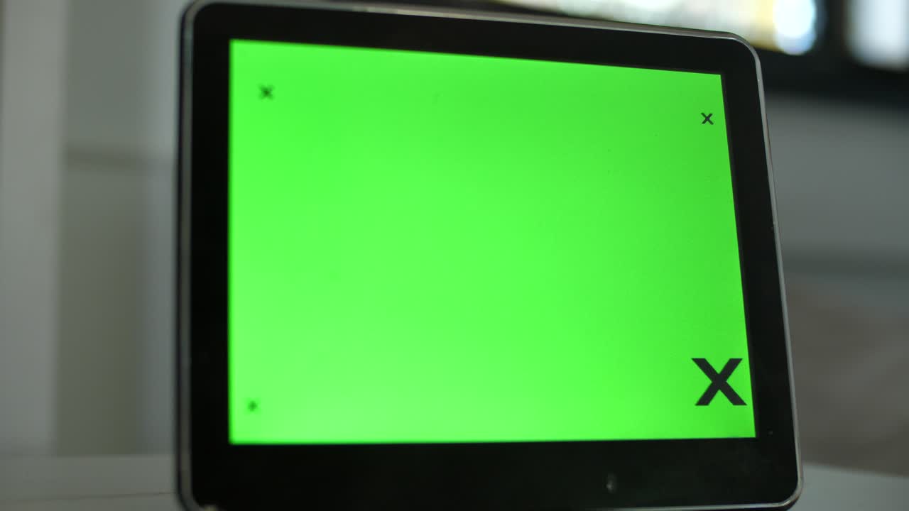  A contemporary digital clock featuring a green display, thoughtfully positioned within a home's living space