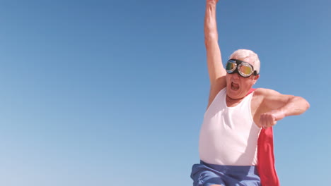 fancy-dress mature man raising arms and jumping