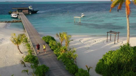 maldives couple walking on dock romantic getaway 4k