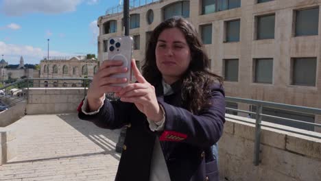 woman taking a picture of a city view