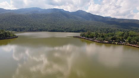 4k drone video as the drone flies up to reveal the bamboo huts along huay tung tao lake near chiang mai in thailand