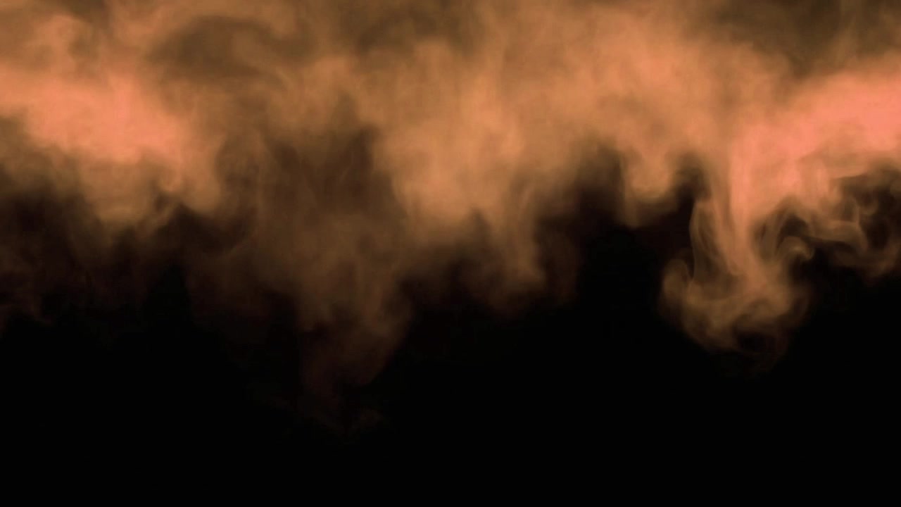 Fumo arancione che sale su sfondo nero