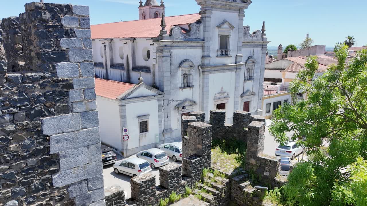 Overlooking Beja Cathedral rising over the walls of Beja Castle in Alentejo, Portugal, on a summer day