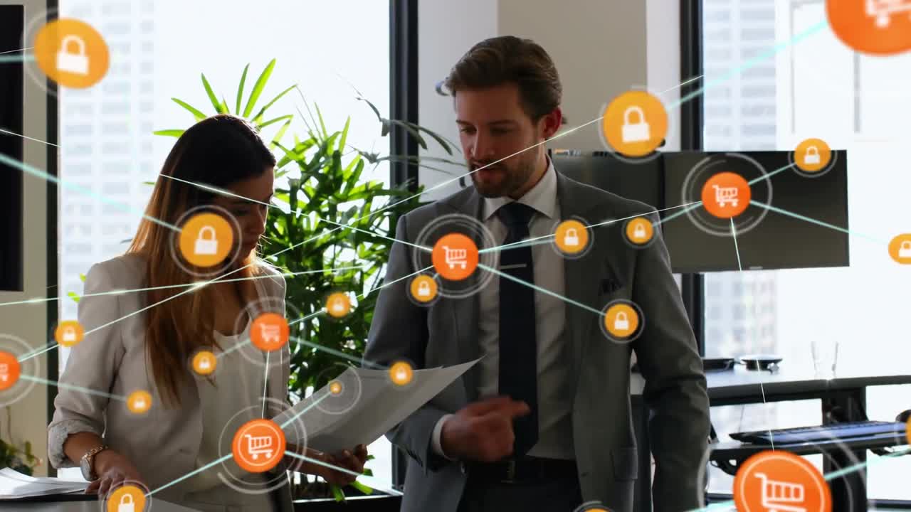 iconos de computadora que se conectan con líneas sobre compañeros de trabajo caucásicos discutiendo documentos en la sala de reuniones