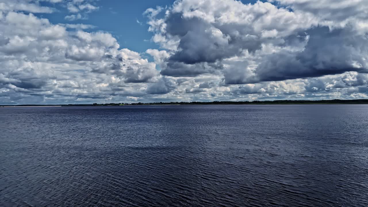 Calm water under dramatic sky at a tranquil lake, evoking serenity