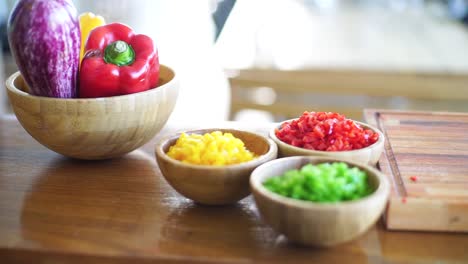 garden-fresh veggies are meticulously sliced and arranged in a rustic wooden bowl, promising a feast of flavors in this captivating stock footage