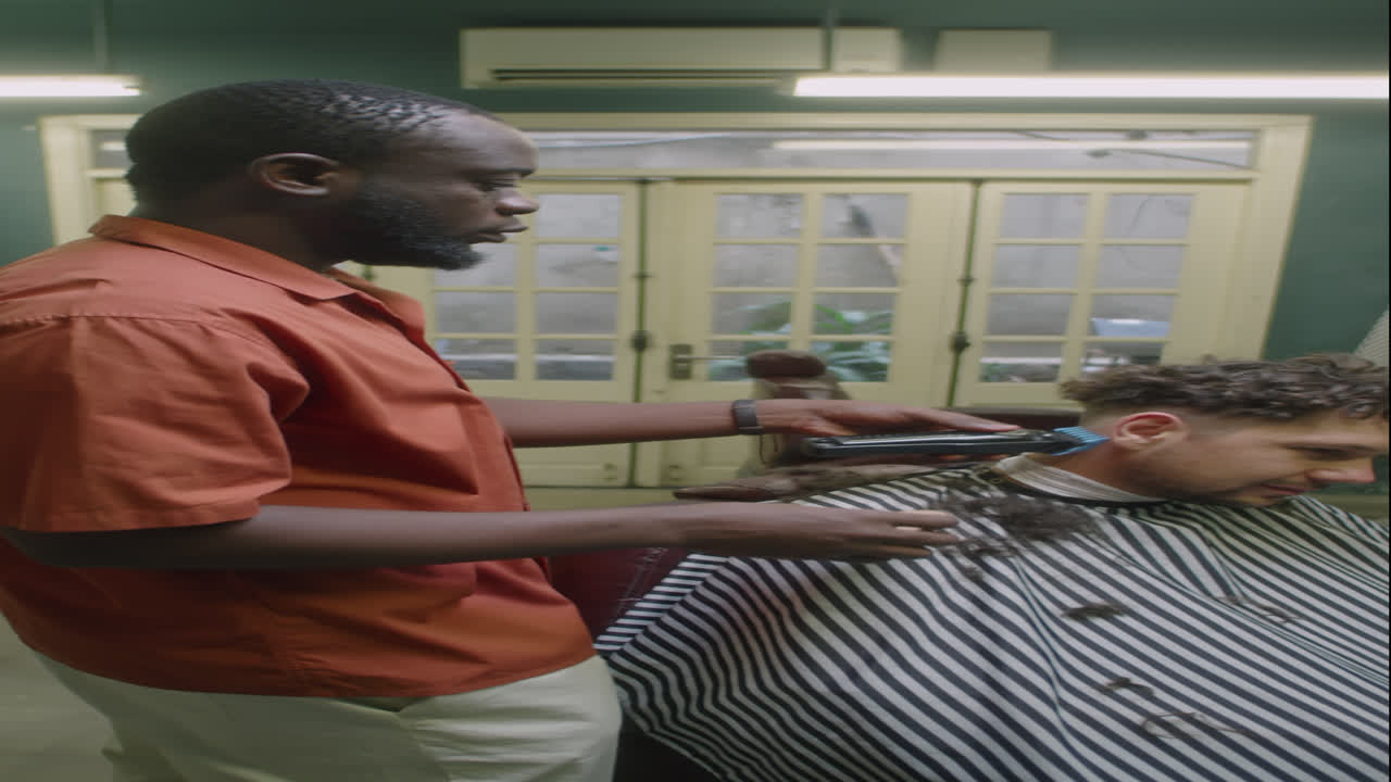 Barber Using Trimmer and Brush for Shaving Neck of Client