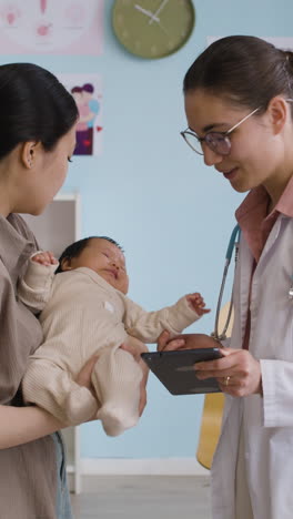 baby checkup with doctor and mother