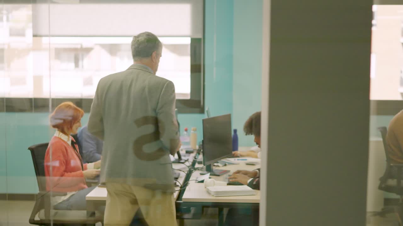 Man delivering files to employees in a coworking space