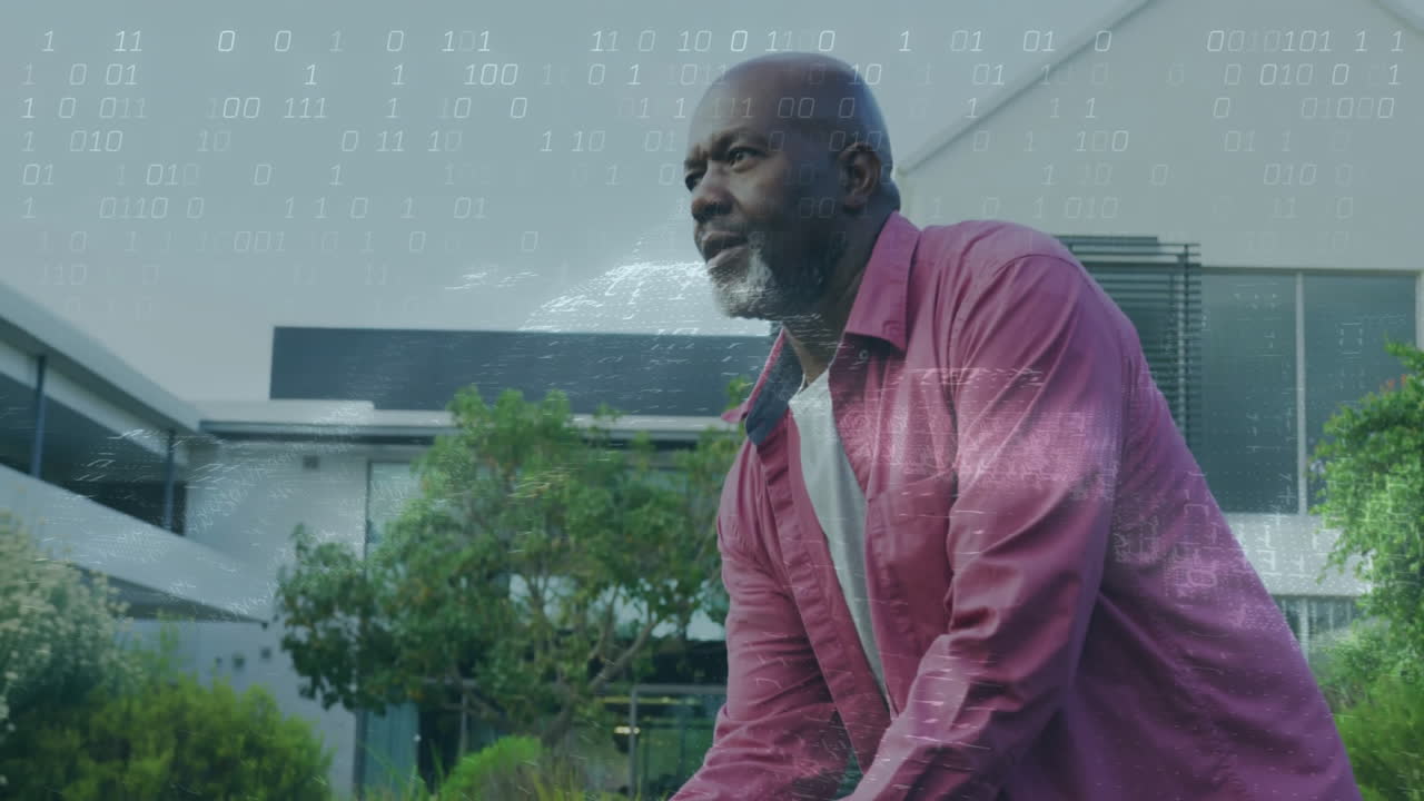 mature man leaning forward in front yard, showing technology with floating digital binary overlay