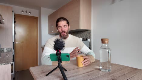man vlogging in his kitchen
