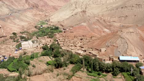 Establishing-shot-of-Tuyoq-valley-in-Xinjiang,-Tuyuk-aerial-of-oasis-village-in-the-Taklamakan-desert,-Flaming-Mountains,-Xinjiang-Uighur,-Region-of-China