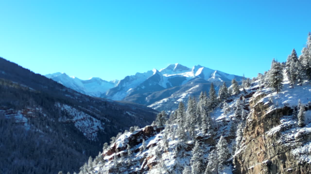 Drone Footage of Snow Covered Peaks and Trees Flying Towards A Beautiful Mountain Located in the Rocky Mountains of Colorado