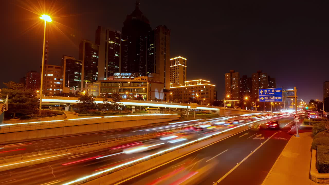 Timelapse urban atmosphere of rush hour traffic jam overpass at the large avenue near skyline landmark high rise building skyscrapers in modern city, financial business center downtown.