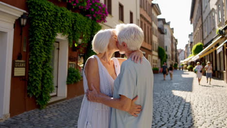 elderly couple sharing affectionate moments on a european cobblestone street