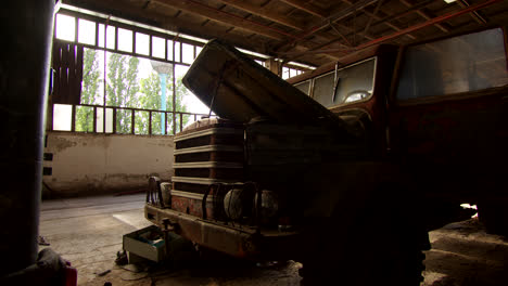 old rusty truck in an abandoned industrial warehouse