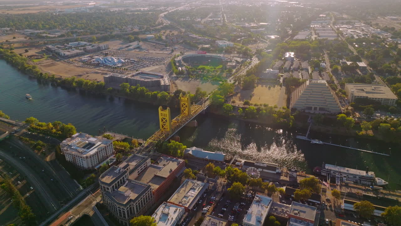 Amazing Sacramento on beautiful sunny daytime. Sacramento River crossing the lively urban city. Aerial view.