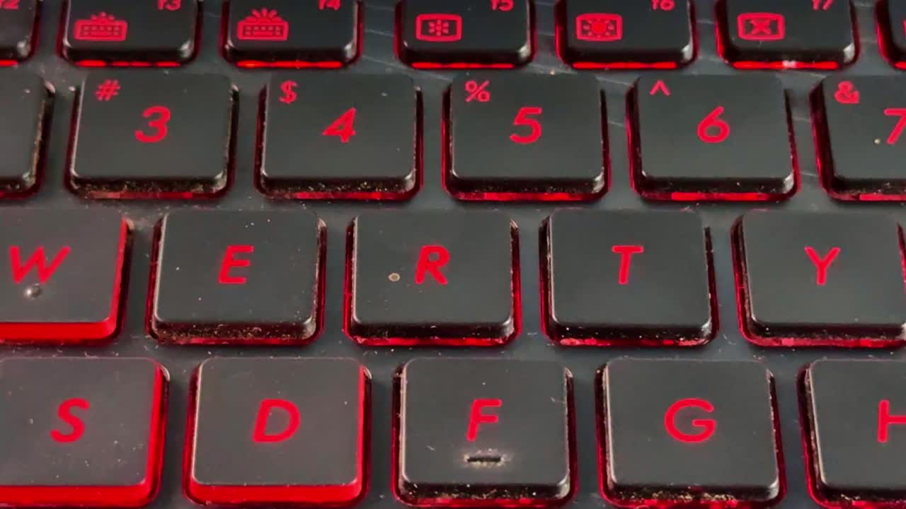 Laptop keyboard typing in "R" close-up with finger interaction, highlighting productivity, work, and digital communication