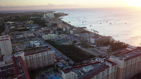 The-coastline-of-Aruba-from-Palm-Beach-with-boats-in-the-Caribbean-Sea-during-sunset