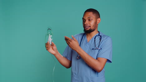 nurse holding handheld nebulizer used for delivering aerosols