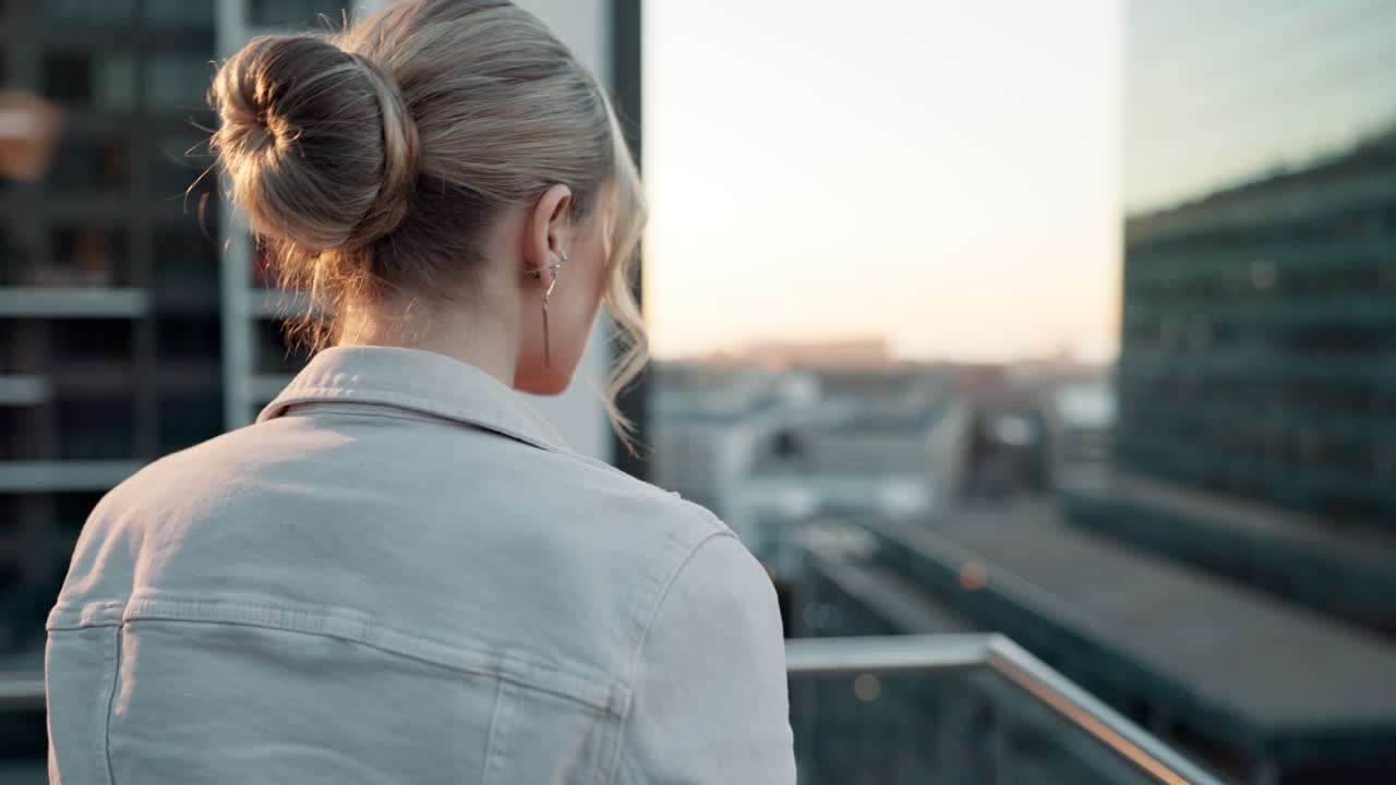 Woman on a rooftop overlooking the city