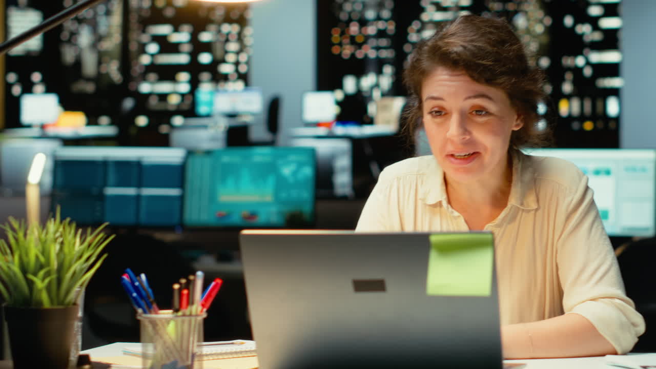 Vertical Video Businesswoman joins an online meeting at night in corporate office