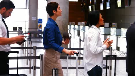 Commuters-standing-in-queue-for-check-in