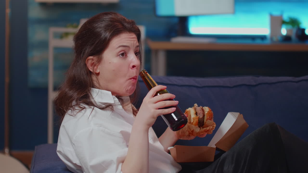 Caucasian person enjoying free time with fast food and television