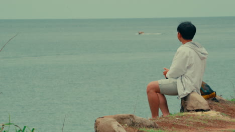 man contemplating the ocean view