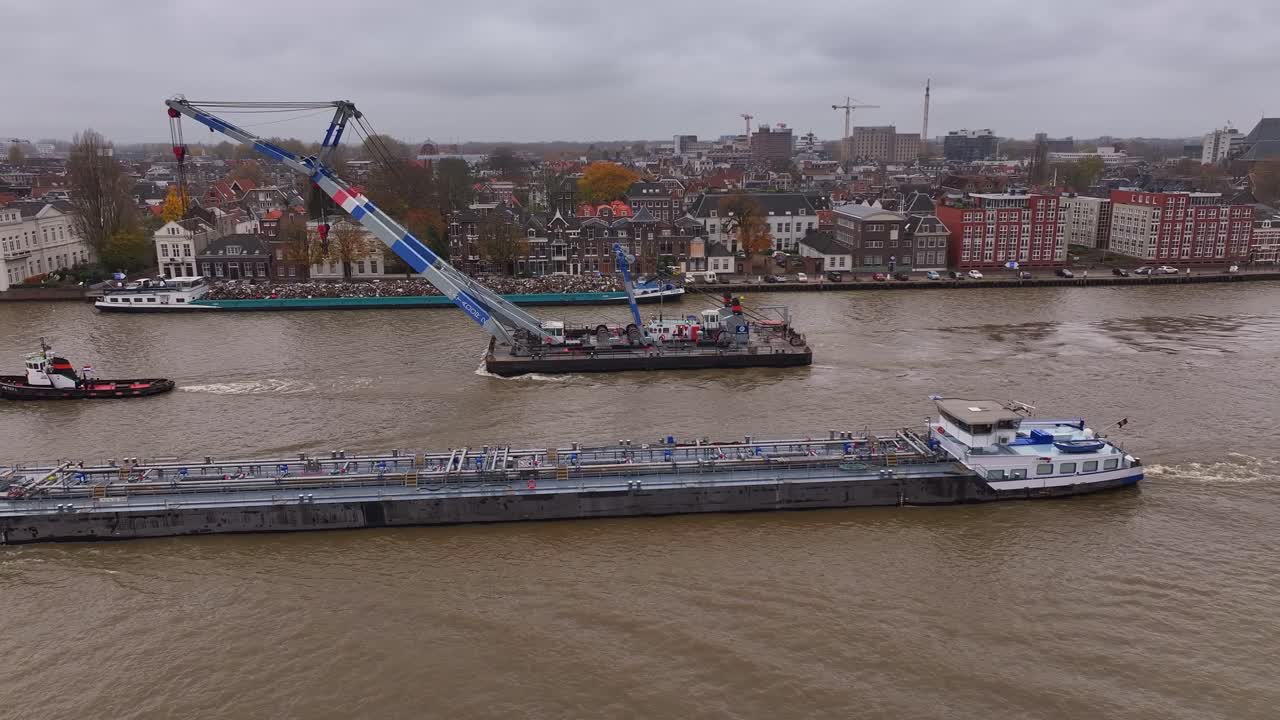 la grúa industrial viaja a lo largo del río oude mass con una presencia dominante.