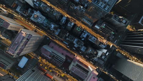 Top down drone shot above buildings and street in Manhattan, sunset in New York
