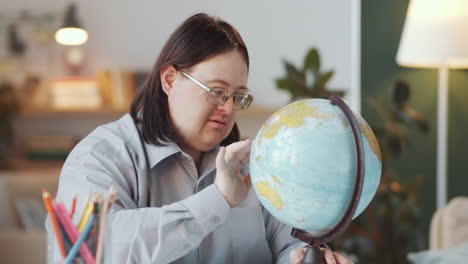 person studying with a globe