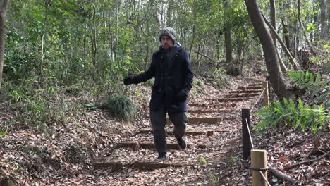 a caucasian guy is descending stairway of a desolate park on daytime