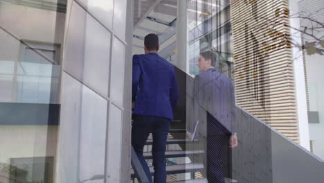 animation of office building over businessmen talking in modern office