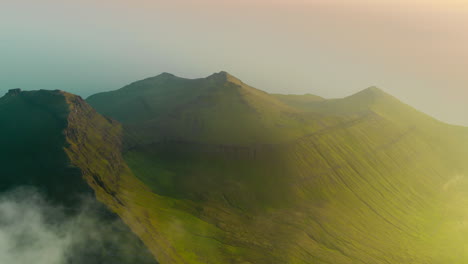 Stunning Aerial View of Lush Green Mountains with Clouds