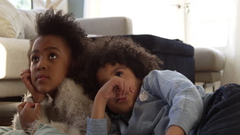 Two-Children-Watching-Television-At-Home-Shot-On-R3D